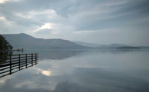 Scenic view of lake against cloudy sky