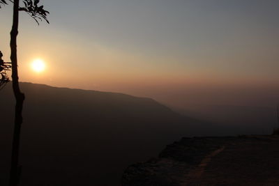 Scenic view of silhouette mountains against sky during sunset