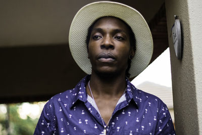 Thoughtful young man wearing hat while looking away