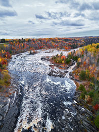 Scenic view of river against sky during autumn