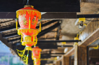 Close-up of illuminated lantern hanging on ceiling of building