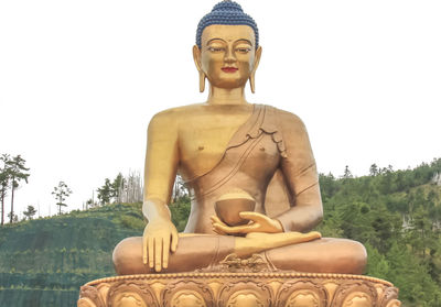 Statue of buddha against clear sky