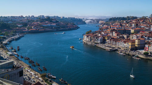 High angle view of cityscape by sea against sky