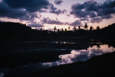 Scenic view of lake against sky at sunset