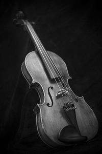 Close-up of violin over black background
