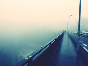 View of road leading towards sea in foggy weather