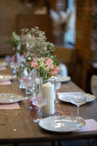 Flower vase on table in restaurant