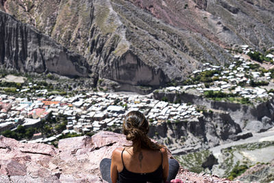 Rear view of woman on rock formations