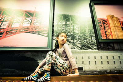 Cute girl sitting on table