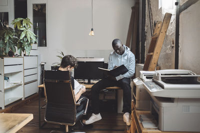 Men sitting on table at home