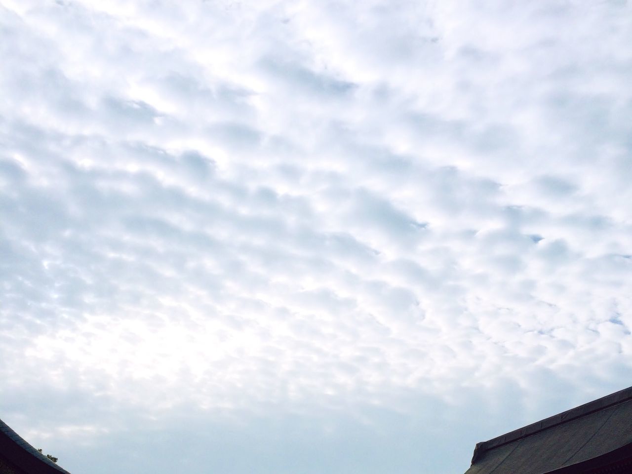 low angle view, sky, building exterior, cloud - sky, architecture, built structure, cloudy, cloud, high section, outdoors, nature, overcast, day, roof, house, weather, no people, cloudscape, building, beauty in nature