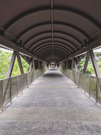 Empty elevated walkway along footbridge