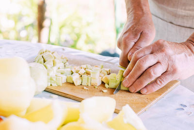 Midsection of man preparing food on table