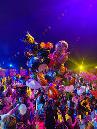 People enjoying illuminated music concert at night