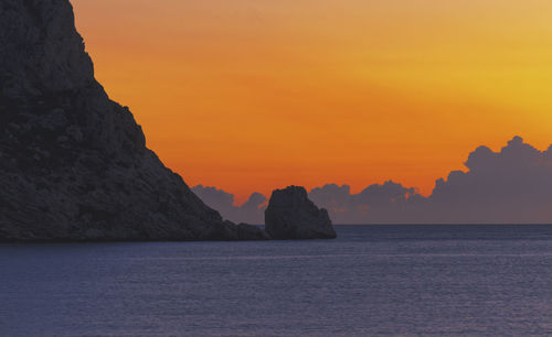 Scenic view of sea against orange sky