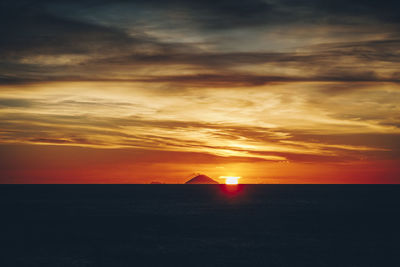 Scenic view of sea against romantic sky at sunset