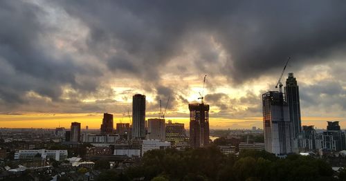 View of cityscape against cloudy sky