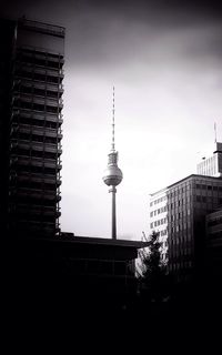 Low angle view of communications tower against sky