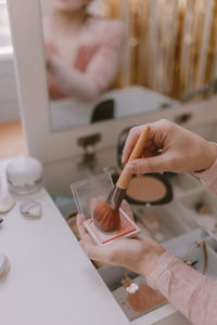 Cropped hands of woman holding make up brush