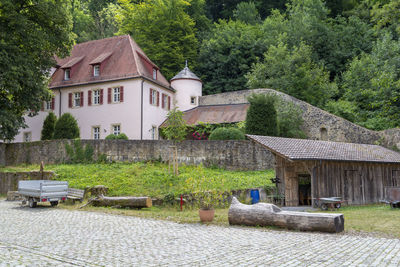 House and trees by plants outside building