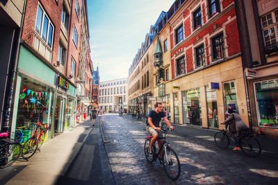 People riding bicycle on city street