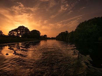 Scenic view of lake against sky during sunset