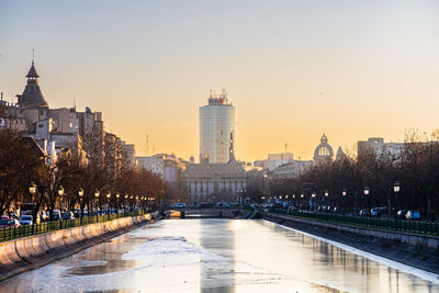 Illuminated city at sunset