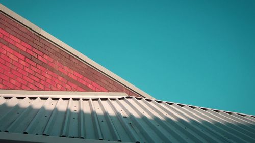 Low angle view of buildings against clear blue sky