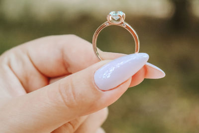 Close-up of hand holding ring