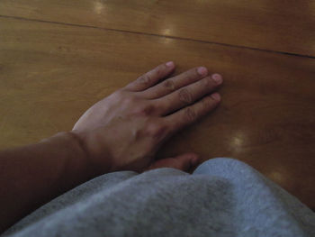 High angle view of couple hands on floor