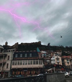 Lightning in city against sky