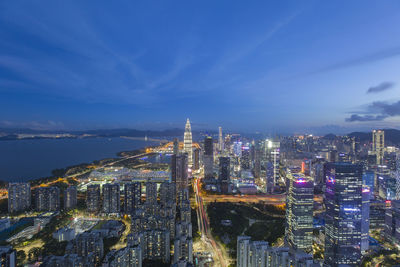 High angle view of illuminated buildings against sky at night