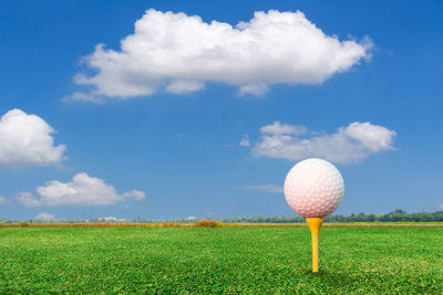 View of golf ball on field against sky