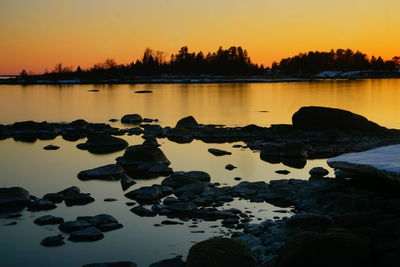 Scenic view of lake against sky during sunset