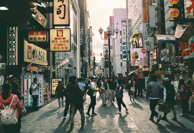 Group of people walking on city street