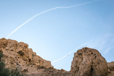 Low angle view of rock formation against sky