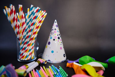 Happy birthday or party background. flat lay wtih birthday hats, confetti and ribbons . top view.
