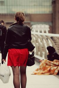 Close-up of woman standing on railing