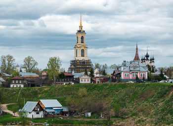 Church by building against sky