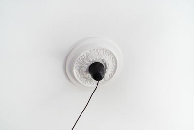 Low angle view of electric lamp against white background