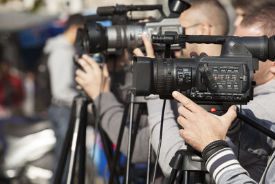 Close-up of men photographing through camera