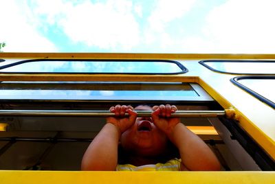 Low angle view of woman standing against sky