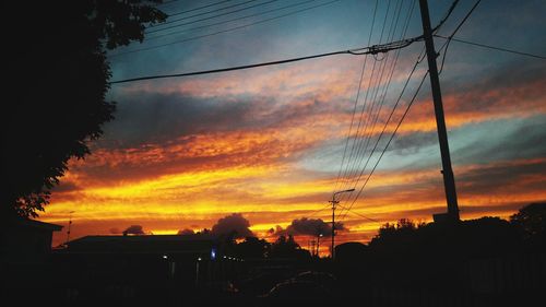 Silhouette trees against sky during sunset