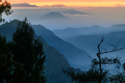 Scenic view of silhouette mountains against sky at sunset