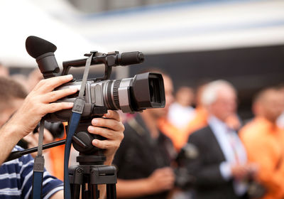 Midsection of cameraman photographing outdoors