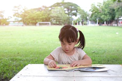 Portrait of girl sitting on table