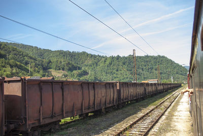 Train on railroad track against sky