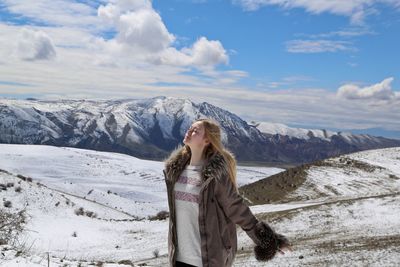 Woman standing on against sky during winter