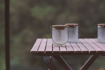 Solar lights on a wooden table, outdoors.