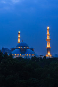 View of illuminated building against blue sky